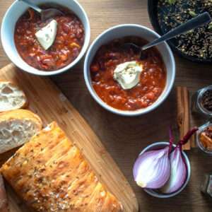 A plate of baked beans, styled as a home-cooked meal